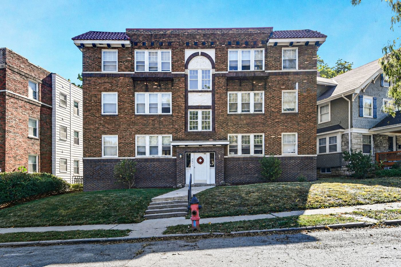 The brick exterior of 2811 Campbell, a vintage three-story apartment building